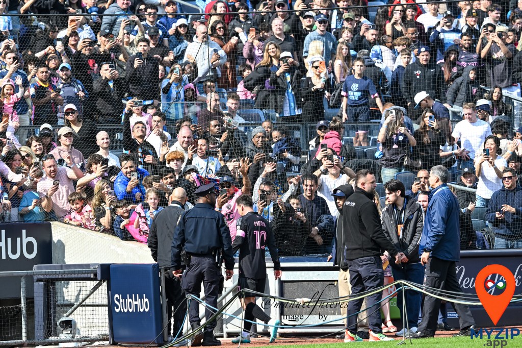Lionel Messi walking toward fans at Yankee Stadium after Inter Miami victory over NYCFC